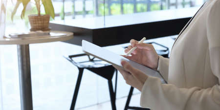 Artist or creative designer drawing on digital tablet with new project design.