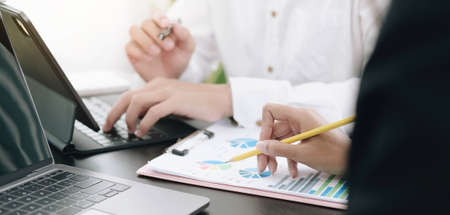 Business people meeting to analyze and discuss the situation on the financial report in meeting...