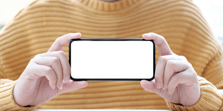 hand holding phone mobile and touching screen isolated on white background, mock-up smartphone matte black colorの写真素材