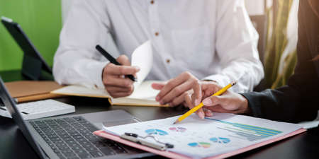 Close up business people discussing the charts and graphs showing the results of their successful...