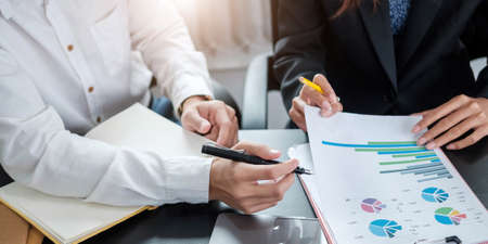 Close up business people discussing the charts and graphs showing the results of their successful...