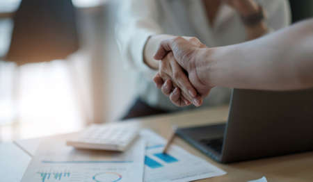 real estate agent holding house key to his client after signing contract,concept for real estate,...