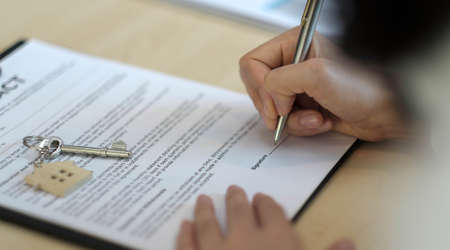 Close up woman signing contract, job agreement, female client putting signature on legal documents, taking loan or mortgage, purchase real estate, insurance or investment dealの写真素材