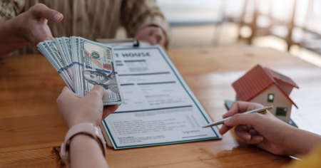 Close up Businessman and partner using calculator and point report for calaulating finance, tax,...