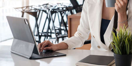 Close up of businesswoman or accountant working keyboard financial data report, accountancy document...