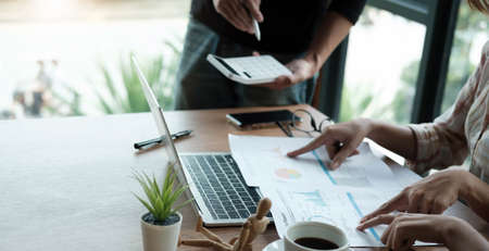 Business meeting time. Photo young account managers crew working with new startup project. Notebook...