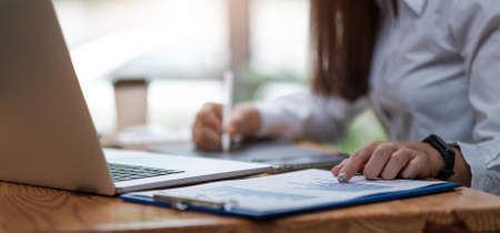 Business woman analysis financial report with tablet computer.