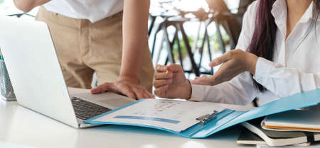 Business team brainstorming in office. Marketing plan researching. Paperwork on the table.の写真素材