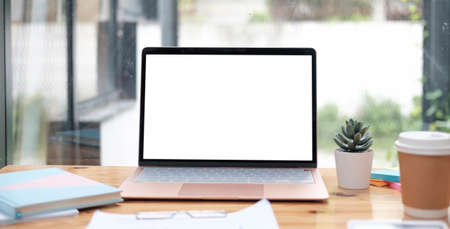 Mockup copy space blank screen laptop and office supplies on white desk.の写真素材
