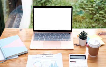 Mockup copy space blank screen laptop and office supplies on white desk.