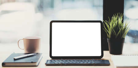 Laptop blank screen on wood table with coffee cafe background, mockup, template for your text, Clipping paths included for background and device screenの写真素材