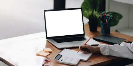 Online class, Student writing on notebook while study at home, Adult woman doing online lesson by using laptop computer, Digital technology education, Work from homeの写真素材