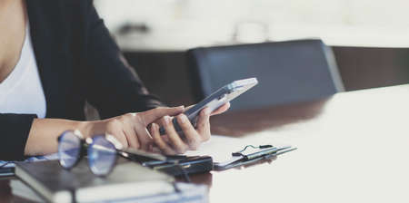 Close up hand of woman using smartphone, texting text message, hipster touch screen on smartphone light bokeh, girls using in hands cellphone close up, online internet.の写真素材