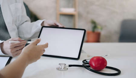 Doctor discussing and explain to patient about life plan. Medicine and health care and insurance concept.の写真素材