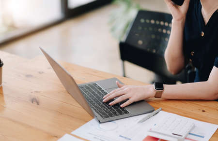 Business woman working in finance and accounting Analyze financial budget at home , Work from home...