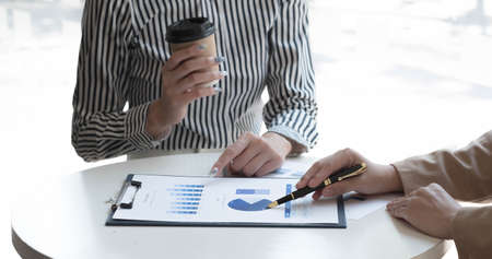 Close up woman are calculating income-expenditure and analyzing real estate investment data,...