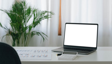 Mockup blank screen laptop on desk. Workspace with laptop and office supplies.