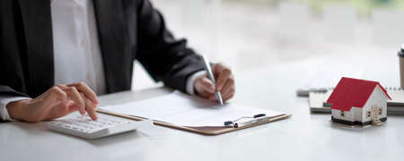 Close up real estate business woman working with pc computer for financial accounting.の写真素材