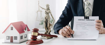Woman accountant or bank worker uses calculator in the office to calculate house loan credit...