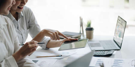 Business team analyzing income charts and graphs with modern laptop computer. Close up.Business...