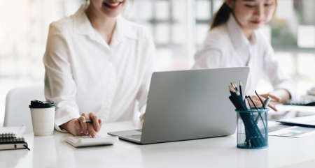 Business team analyzing income charts and graphs with modern laptop computer. Close up.Business analysis and strategy concept.の写真素材