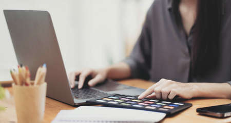 Young man working on his laptop with blank copy space screen for your advertising text message in...