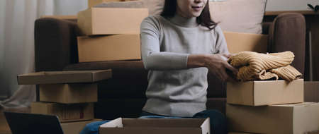 Business Start up SME concept. Young startup entrepreneur small business owner working at home, packaging and delivery situation.の写真素材