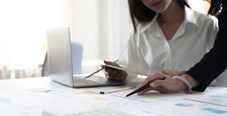 Business People Meeting using laptop computer, calculator,notebook,stock market chart paper for analysis Plans to improve quality next month. Conference Discussion Corporate Conceptの写真素材