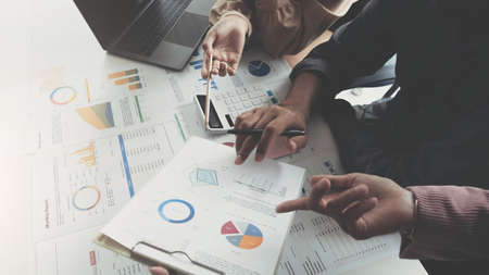 Business team analyzing income charts and graphs with modern laptop computer. Close up.Business...
