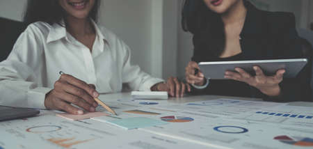 Asian business adviser meeting to analyze and discuss the situation on the financial report in the meeting room.Investment Consultant,Financial Consultant,Financial advisor and accounting conceptの写真素材