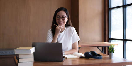 Asian women are bored from their online studies, have a sad face and have been tired from their...