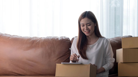 Successful Woman Entrepreneur With Parcel Boxes In Her Own Job Shopping Online Business At Home
