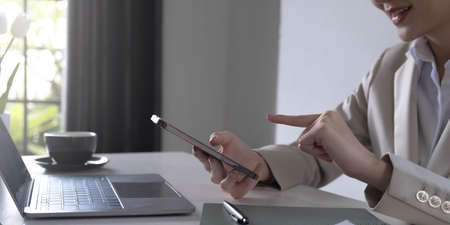 Young asian businesswoman beautiful charming smiling and talking on the mobile phone in the office.