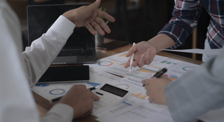 Business team colleagues discussing working analysis with financial data and marketing growth report graph in team, Meeting Talking Brainstorming Communication Conceptの写真素材