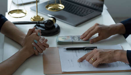 business people and lawyers discussing contract papers sitting at the table. Concepts of law,...