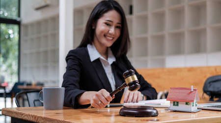 Business woman or lawyers working on wooden desk in office. Law, legal services, advice,Judge auction and real estate concept.の写真素材