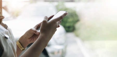 Close up man using calculator and holding credit card at home.の写真素材