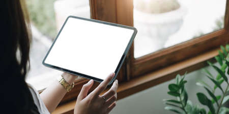 Close up man using calculator and holding credit card at home.の写真素材