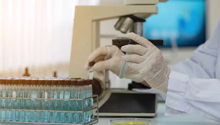 Biochemistry laboratory research, Chemist is analyzing sample in laboratory with Microscope...