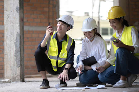 Professional Construction and Engineer team Working on workplace. Professional black architect and...