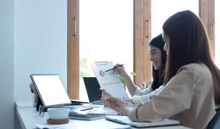 Business team briefing the idea concept before the next meeting in modern office with laptop computerの写真素材