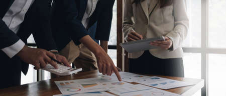 Asian business adviser meeting to analyze and discuss the situation on the financial report in the...
