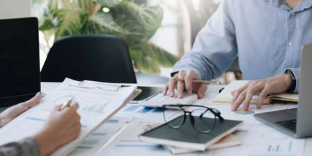 Team of business people working together in the meeting room office, teamwork background charts and graphs banner, double exposure successful teamwork,business planning concept.の写真素材