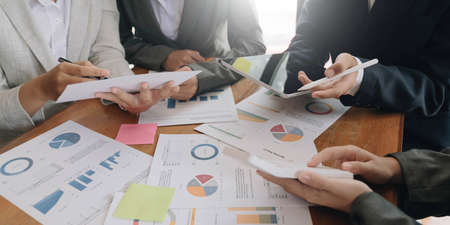 Team of business people working together in the meeting room office, teamwork background charts and...