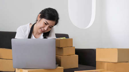 Startup small business SME, Entrepreneur owner using smartphone or tablet taking receive and...