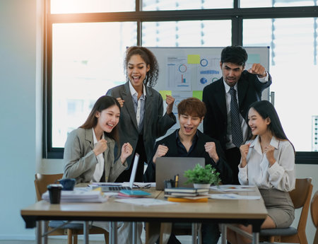 Female Operations Manager Holds Meeting Presentation for a Team of Economists. Asian Woman Uses Digital Whiteboard with Growth Analysis, Charts, Statistics and Data. People Work in Business Office.の写真素材
