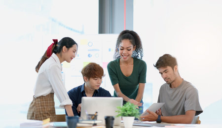 Group of asian business meeting and discussing with new startup idea project. Creative business people planning strategy analysis and brainstorm with document report in officeの写真素材