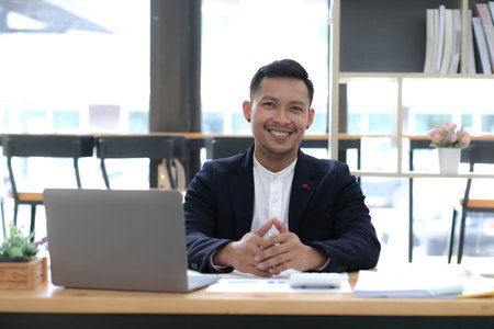 Startup successful small businessman owner sme stand with tablet smartphone in coffee shop restaurant. Portrait of asian tan man barista cafe owner. SME entrepreneur seller business conceptの写真素材