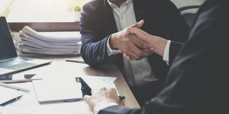 Business people shaking hands, finishing up meeting, business etiquette, congratulation, merger and acquisition conceptの写真素材