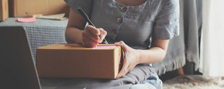 Small Entrepreneurs Start A Home Business By Arranging Goods With Brown Parcel Boxes, Small Home Business Startup Ideas.の写真素材